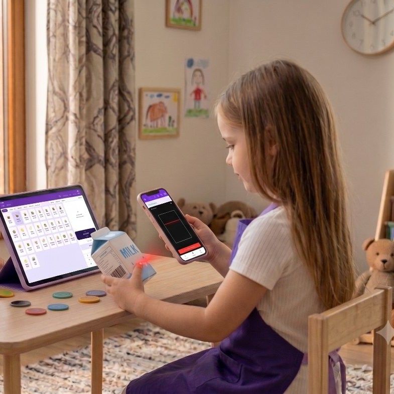 A girl scans the barcode on a milk carton with a phone, next to a tablet running the KidRoles register